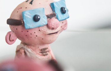 Animation BA(Hons) model of a bald man wearing large blue glasses