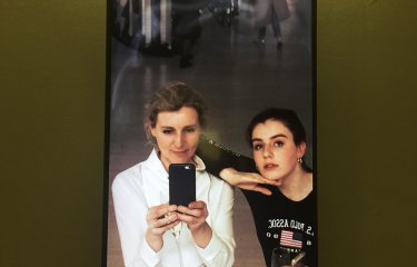 Two Falmouth University students taking a photo of themselves in a mirror