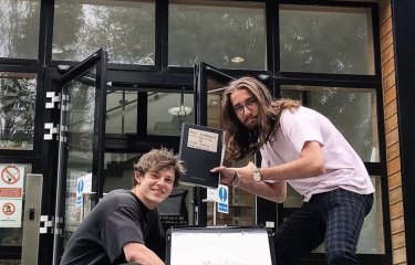 Max and Jake outside the School of Communication