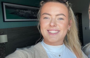 Falmouth University student smiling with blonde hair and a nose ring