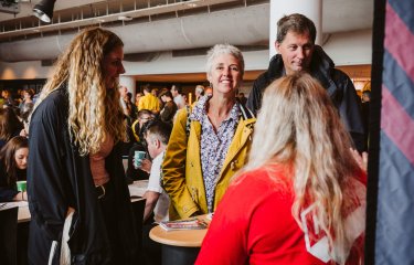 Parents smiling with daughter at an Open Day at Falmouth University