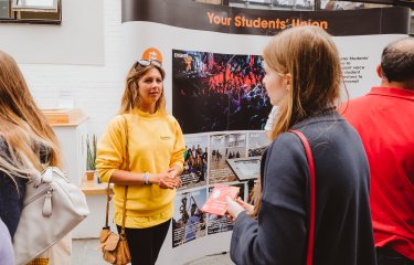 Open day ambassador talking to prospective student.