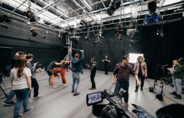 Film and television studio with students filming a fighting scene