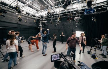 Film and television studio with students filming a fighting scene