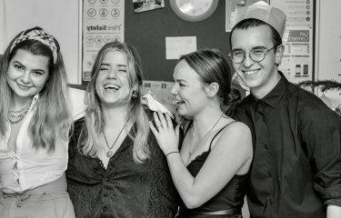 International student Orestis posing with friends at a Christmas party