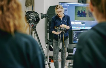 Falmouth Photography lecturer using camera equipment in a studio