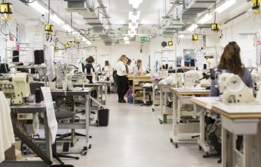 A view of the fashion department facilities at Falmouth University with tables with sewing machines.