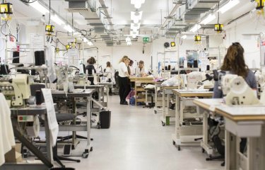 A view of the fashion department facilities at Falmouth University with tables with sewing machines.
