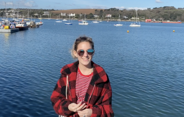 Picture of Amy Wood, student content creator and Ambassador, by the sea in Falmouth.
