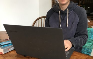 student records her contribution for the first radio show from her dining table at home 