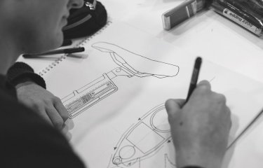 Student drawing design for a bike seat.