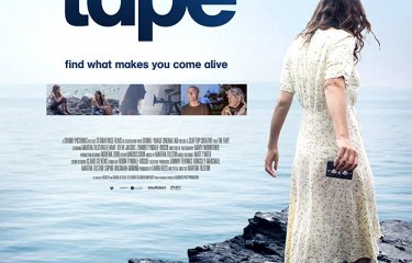 Film poster for 'The Tape'. A woman in a white dress with her back to us, a guitar at her feet.