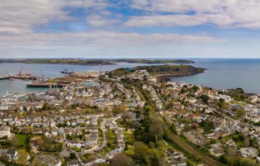 View from above of Falmouth, houses, coastline, sea and clouds.
