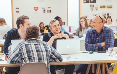 Students and a teacher in a graphic design studio