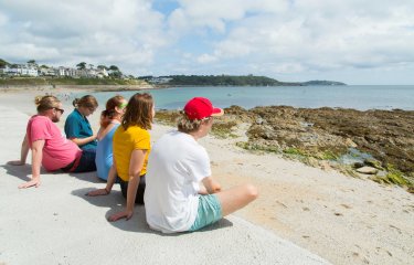Students sat looking out to sea 