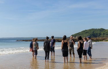 BA Creative Writing (Online) students on the beach with Wyl Menmuir 