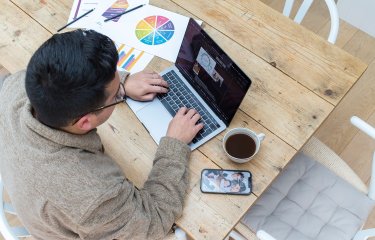 Person sat at a desk working on a laptop