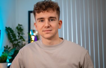 MA UX Design graduate Jack Jenkins sitting in his home office 