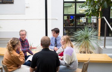 Journalism students sitting in a circle