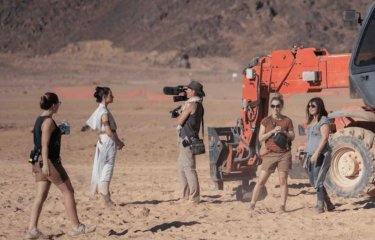 Four women shooting a documentary about the making of Star Wars on a desert-like set