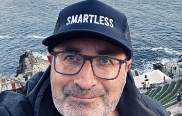 Headshot of comedy writing course leader wearing a cap