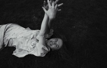 A girl lying in a field