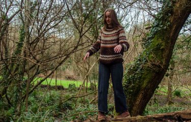Emily Collis, Musician, standing in a woodland scene