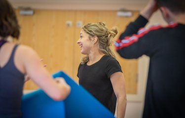 A small group of people looking away from the camera after completing a dance fitness class