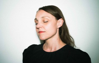 A headshot image of dance & choreographer Emily Alden