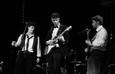 Black and white image of three musicians with the bass player in the centre