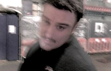A blurred headshot of Joel Yarwood
