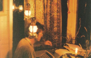 An image of Nick Darke writing at a desk
