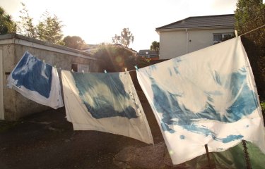 An external image of painted cloth on a washing line