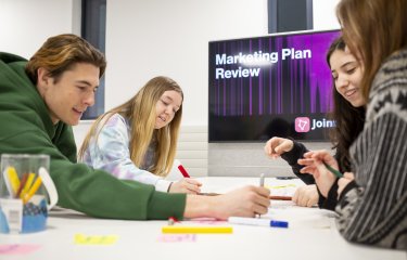 Group of students sat round a table mind mapping