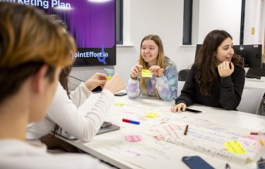 Group of students sat round a table mind mapping