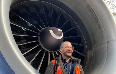 UX Design online tutor Cralos stood next to an airplane engine