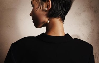Photograph of the back of the head of a woman with cropped black hair