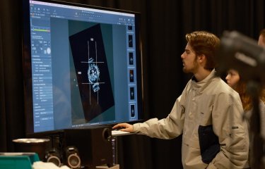 A Falmouth University Commercial Photography student editing a photograph of a watch on a large screen