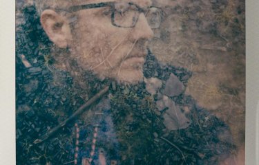 Polaroid of a man wearing glasses