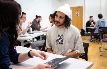 A student taking part in a portfolio review at the Falmouth University Games Expo