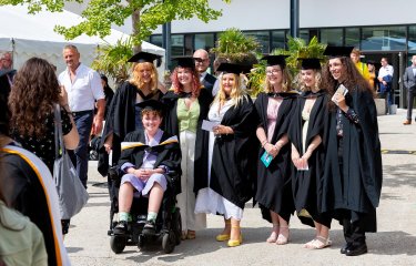 A group of students in gowns at Falmouth University's 2023 graduation
