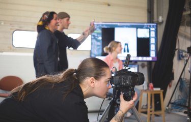 Fashion photography student taking photo in studio