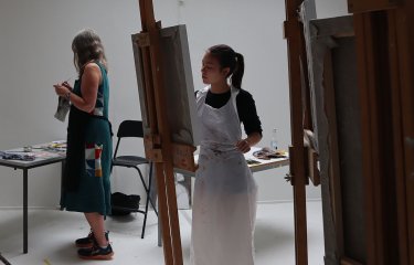 People painting from easels
