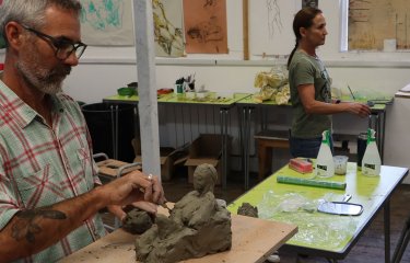 Two students creating sculptures