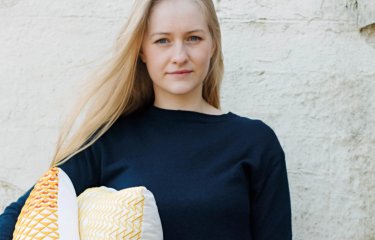 A woman holding some cushions