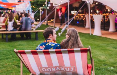 Two students sat on an oversized deckchair