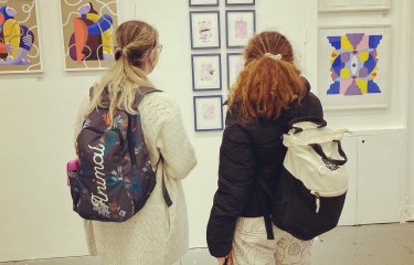 Students admire work at an illustration exhibition in Bristol 