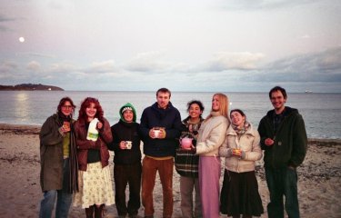 Falmouth University students on Gylly Beach at dusk