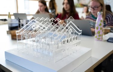 Clear plastic model of a building with a pitched roof