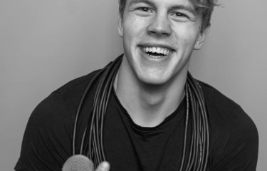A man holding microphones in black and white